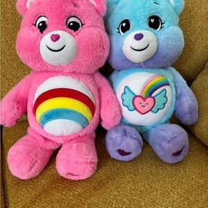 Cheer bear and rainbow badge bear from the “unlock the magic series.